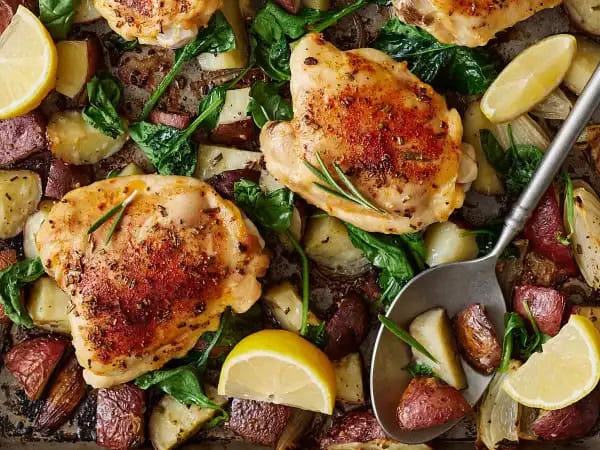 image 20699 - Dinner will be ready in 1 hour. That's a promise with this Dinner Table Chicken! Succulent, deeply flavorful chicken thighs, delicately seasoned and roasted with hearty red potatoes and wilted, garden-fresh spinach. Top it with a little lemon for brightness and you'll find that Dinner Table Chicken is a complete meal on a single sheet pan. That sounds and tastes pretty good to us!