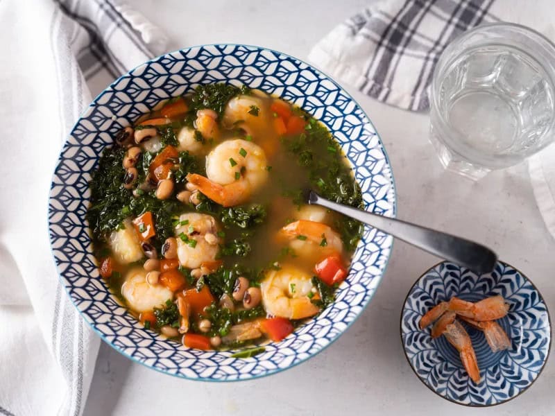 image 21712 - Straight from the Carolinas comes Carolina Shrimp Soup: the tastiest dinnertime dish this side of the Mississippi! Pink, sweet, and savory shrimp, garden fresh and tender kale, and hearty black-eyed peas swimming in a sea of captivating chicken broth! Carolina Shrimp Soup is a literal ocean of flavor inviting you to dip your spoon in and dig into the flavors! Mmmmmm, let the goodness wash over your tastebuds!
