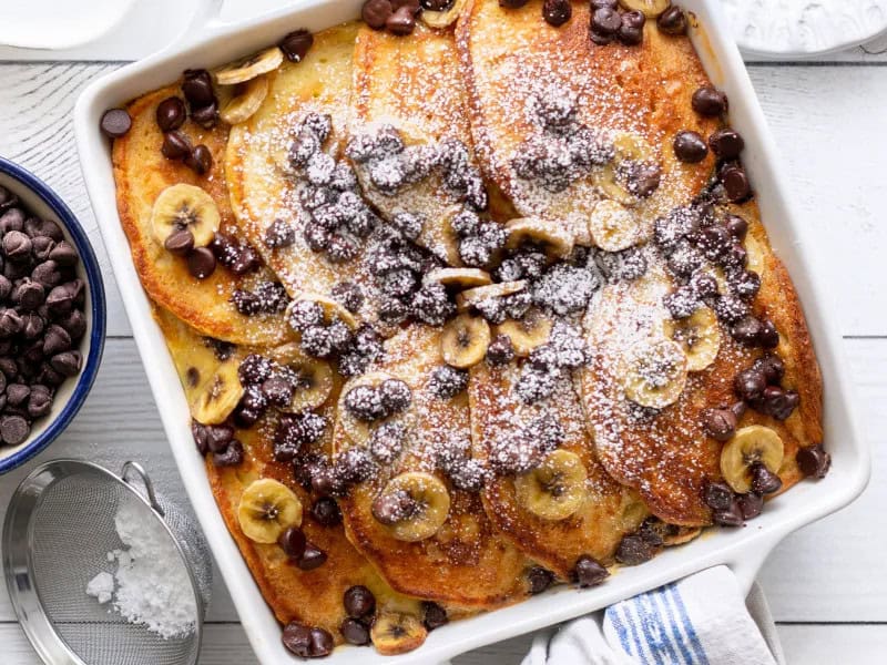 image 21720 - Say good morning to one of the best things that will ever grace your kitchen. There are just some things that go better together, and this holds true more than ever with Perfect-Pair Pancake Casserole! Layers of golden, fluffy pancakes, topped with fresh, ripe bananas and scattered with gooey chocolate chips make for a divine combination. This easy-to-make recipe we've so accurately named Perfect-Pair Pancake Casserole will be the most requested dish at all of your breakfast and brunch events. You can never go wrong with pancakes, bananas, and chocolate, especially first thing in the morning. Make sure you try this perfect pairing. You just can't find a better combo!