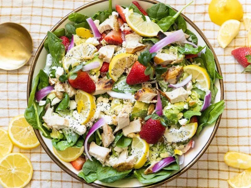 image 2173 - The most perfect warm-weather salad is here! Strawberry & Chicken Salad combines tender savory chicken breast, sharp feta cheese, and bright strawberries. Adorned with a citrusy, nutty, and fatty dressing, this salad looks as good as its taste. Strawberry & Chicken Salad only takes 30 minutes or less to make, so you can have it ready for a sunset dinner on the patio in no time!