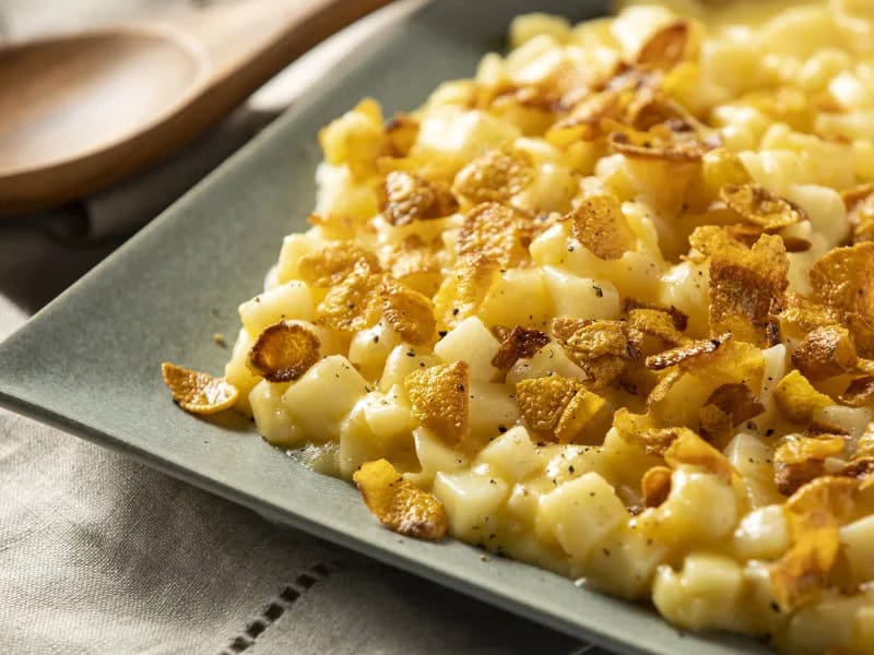 image 21942 - If you're craving an indulgent, hearty side dish, you've come to the right place. Creamy Scalloped Potatoes bring you flavor you thought was only possible in your dreams! The combination of crispy hashbrowns, melty cheddar cheese, and a cornflake-butter crumble creates a culinary experience that will have you savoring every rich, mouthwatering bite. Baked to golden-brown perfection, Creamy Scalloped Potatoes will have everyone asking for the recipe... and for seconds!
