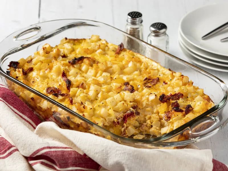 image 22084 - Oh yes, it's time to get that bacon! Get-That-Bacon Bake puts the succulent and savory bacon front and center, cushioning them in a bed of fluffy eggs. Hearty potatoes and melty sharp cheese help to make breakfast even more satisfying while accenting the flavor of the bacon. Trust us, nothing makes you feel wealthier than a heaping helping of Get-That-Bacon Bake! The best news is that you can share the wealth since it makes enough for everyone!
