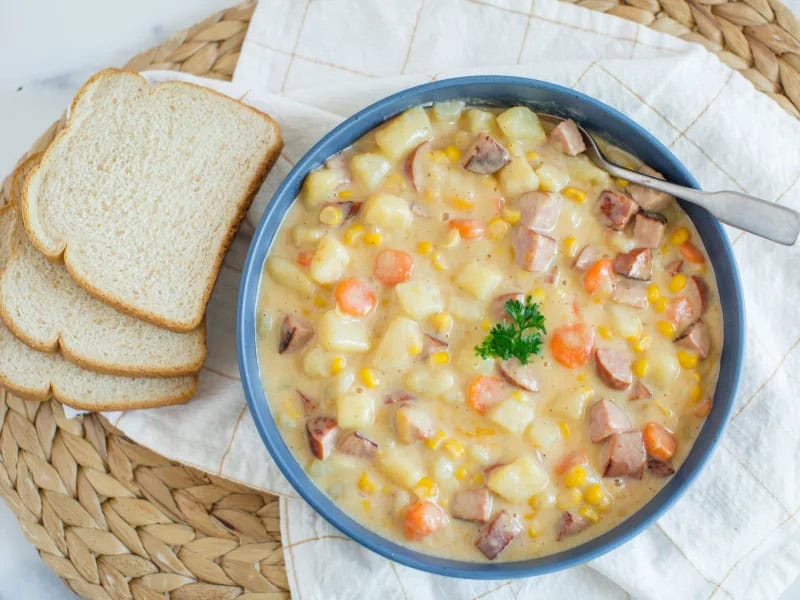 image 22251 - The air is frigid. The stars seem brighter than ever. You're wrapped up in a blanket by the fire. You don't just need a meal; you need a dish that will warm you from the inside! Cold Night Soup is precisely that. Swimming in a creamy chicken broth, you'll find fluffy potatoes, spicy, savory kielbasa, and melty cheese: everything you need to nourish body and soul when there's a chill. Garden vegetables round out this hearty, simmering soup. Cold Night Soup puts a stop to cold nights... there's only comfy nights from here on out!