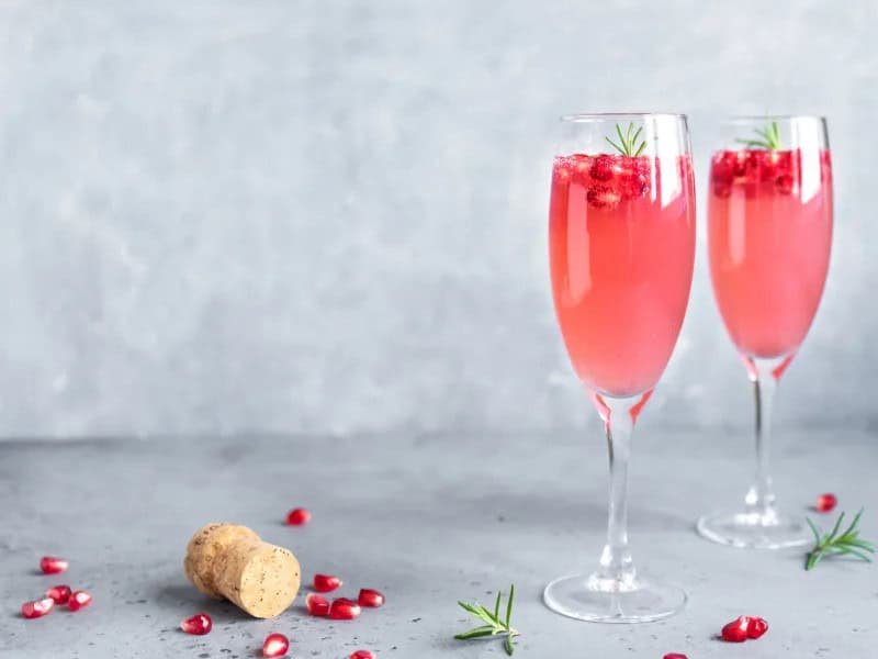 image 2449 - The French 75 has been ringing in the holidays since the 1920s (and maybe earlier) and has always had a festive kick. Yet even it could use a splash of Christmas color! Pomegranate French 75 combines the bubbling, boozy, heady champagne and gin brew with the sweet and vibrant tartness of pomegranate juice. The drink becomes a luscious, rosy pink that feels as romantic and enchanting as the holidays can be! Pomegranate French 75 is a drink so delicious you’ll want to raise a glass to it!