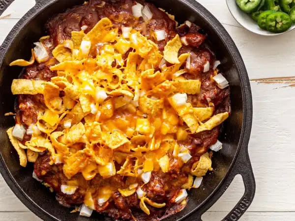 image 3441 - Corn Chip Pie is one of those Southern favorites that charms just about everyone that tries it. The corn chip crust is distinctly crunchy and flavorful, offering a welcoming contrast to the spicy, hearty, meaty chili and melty cheese. It's a fantastically easy and speedy dish to make too, perfect for when time is short, but the desire for comfort is great! No matter where in the U.S. you live, you'll find a new favorite with this Corn Chip Pie!