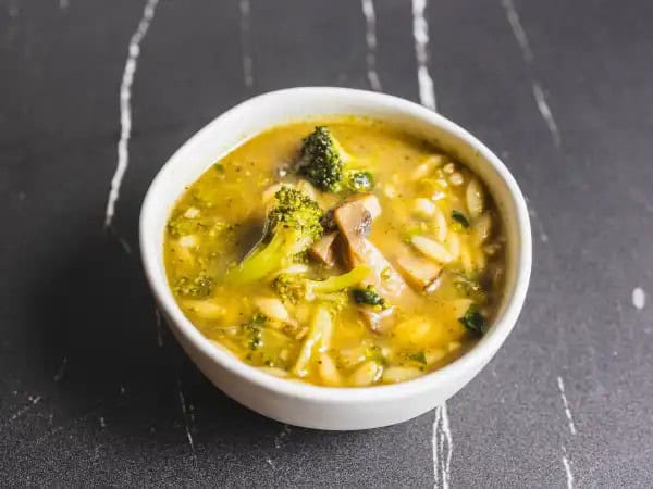 image 6120 - For all the mushroom lovers everywhere, here is a soup made just for you! Superb Mushroom Soup has beefy, tender mushrooms front and center, swimming in your favorite broth with plenty of hearty orzo and wilted, garden-fresh spinach to bring out the best in each spoonful! Bites of broccoli and dollops of herbaceous basil pesto really help make Superb Mushroom Soup feel just so fresh and filling. Find your favorite spoon and dig into your new favorite soup!