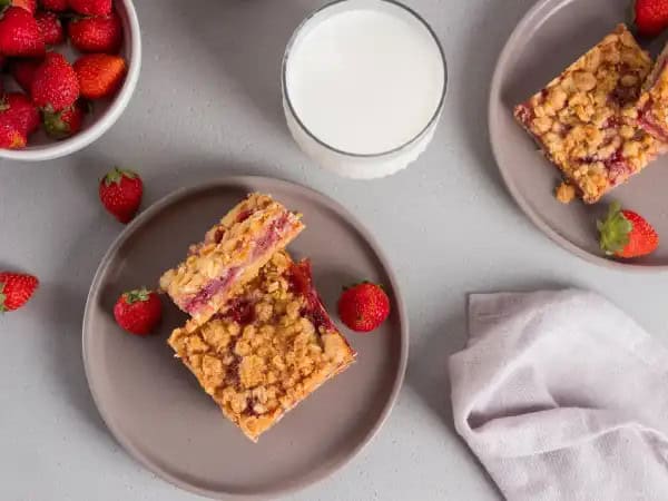 image 7514 - Love makes you feel like every day is summer! And these Strawberry Love Bars are perfect for bringing the summer experience even during the wintry cold of Valentine's Day! Each bar is filled with a vibrant, sunny strawberry sauce sandwiched between layers of a buttery, crisp crumble! Strawberry Love Bars are simple to make, and will be a welcome morning treat for your someone special!