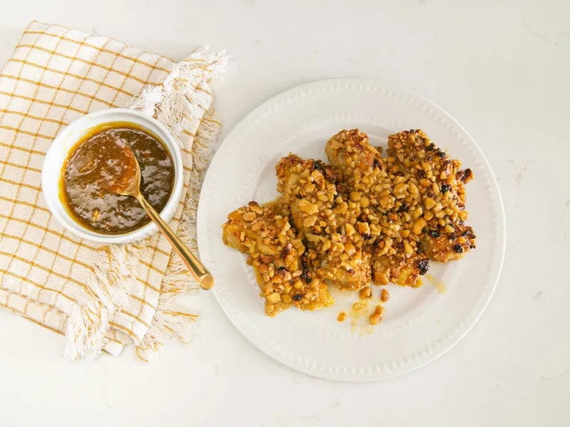 image 8662 - Chicken breasts just got a whole lot more interesting with this Cashew Crusted Chicken. Not only is the meat coated by this tasty crunchy nut, but it’s also flavored with out-of-the-box ingredients like curry powder, mustard, and apricot jam. The result is a one-of-a-kind dinner you’ll be dying to share with friends. Serve the Cashew Crusted Chicken with a green salad and focaccia bread.