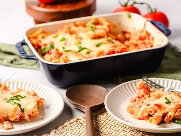 image 8749 - Worrying about what to make for Sunday dinner is a thing of the past. Now, Chicken Ziti Bake reigns supreme! The tender ziti is exactly the right pasta to scoop up the rich, sweet, and vibrant tomato sauce with just the right amount of heat and the savory shredded chicken. And of course, topping everything with the classic mozzarella and parmesan cheese combination makes everything just a little happier. Chicken Ziti Bake is ready in just an hour, so no need to sweat over a hot stove all day for an amazing pasta dinner!