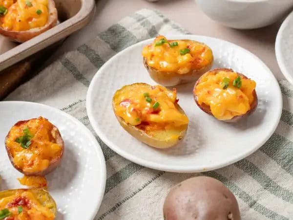 image 8813 - Tiny but mighty, these Halftime Show Bites run to the "I-need-a-good-snack" goal line like no other! Baby potatoes tackle your hunger when sacked full of a creamy pimiento cheese and almost-twice-baked potato-like filling when broiled to golden delight. Halftime Show Bites may become the full-time snack request at all your extra-curricular events. They're definitely a winner!