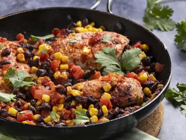 image 8870 - It's always a party when New Mexico's Fiesta Chicken is on the table. It's hard not to celebrate such a savory, vibrant dish, when the chicken is simmered with summery corn, hearty beans, and bright tomatoes! Chilies add a little heat, keeping New Mexico's Fiesta Chicken dancing on your tastebuds. You'll be tempted to get up in dance too, that's the spirit of this dish after all!