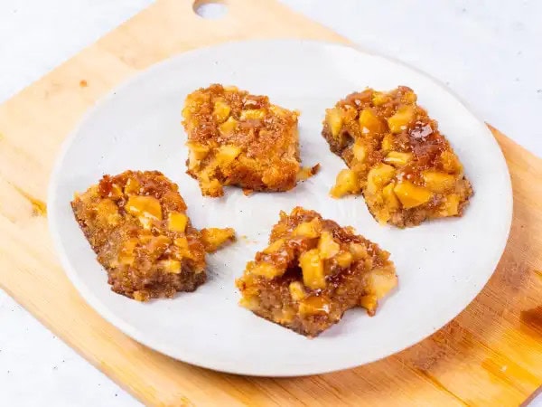 image 9116 - There's some saying about how eating apples every day will keep you from going to the doctor... well, we have found the loophole, because they never specified what kind of apple you have to eat. Say we eat these Apple Blondies once a day. Do you think their crispy, caramel-y goodness that's packed with apples (of course) would do the trick? Surely that sticky, maple-y glaze drizzled on top is just what the doctor ordered. We guess the only way to find out is to experiment with these Apple Blondies. See ya, later doc! We've found your really sweet secret!