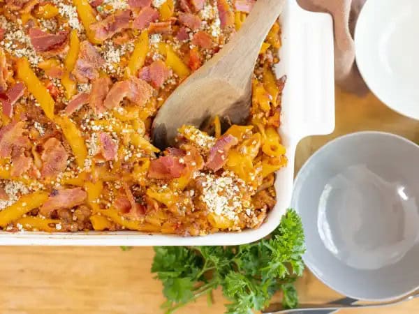 image 9779 - There can never be enough burgers, can there? At least, that's the feeling we get while eating a particularly delicious burger; a feeling perfectly captured by the Bistro Burger Bake. Fortunately, there are plenty of burgers to go around with this casserole! Every bite has everything you could ever want in a burger: savory beef (of course), tangy and sweet condiments, juicy tomatoes, succulent bacon, and melty, sharp cheeses. It even has breadcrumbs for the toasted bun taste! Bistro Burger Bake is something you'll be happy to have on your table; no drive-thru required!