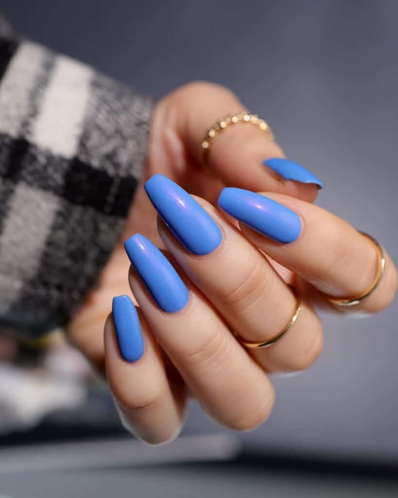 Varied blue nail designs showcasing light blue nails, royal blue acrylic nails, and blue French tips in different hand poses.