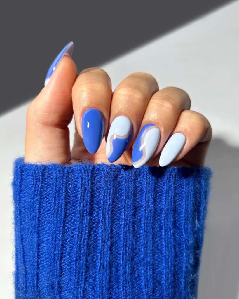 Varied blue nail designs showcasing light blue nails, royal blue acrylic nails, and blue French tips in different hand poses.