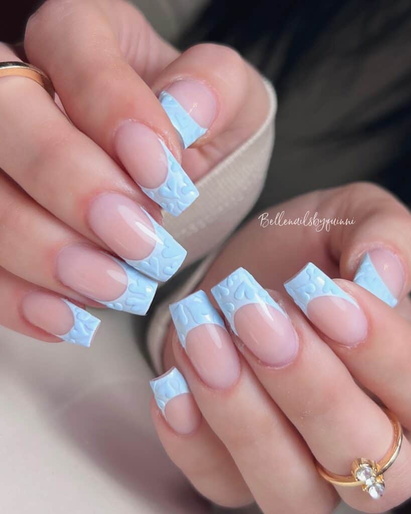 Varied blue nail designs showcasing light blue nails, royal blue acrylic nails, and blue French tips in different hand poses.