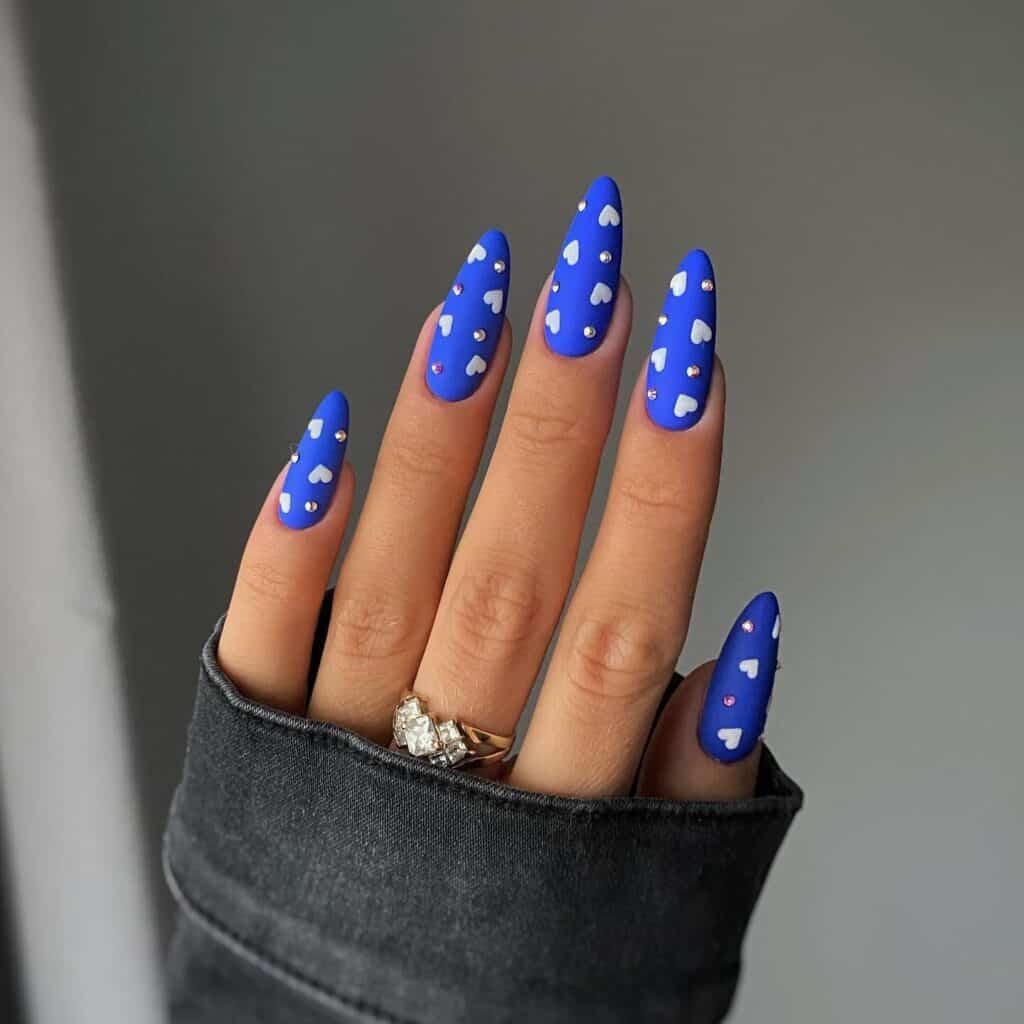 Varied blue nail designs showcasing light blue nails, royal blue acrylic nails, and blue French tips in different hand poses.