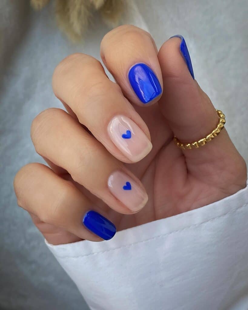 Varied blue nail designs showcasing light blue nails, royal blue acrylic nails, and blue French tips in different hand poses.