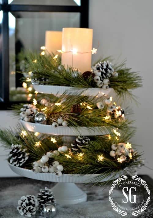 DECOR STEAL CHRISTMAS PINE AND STARS CANDLE pinecones and snowstonegableblog.com - Christmas is a time of joy and celebration, and one of the best ways to bring that festive spirit into your home is through tiered tray décor. These charming and versatile pieces can transform any space, adding layers of holiday cheer with minimal effort. Whether you’re a fan of rustic farmhouse styles or prefer a more elegant look, there are countless ways to make your tiered tray shine this season.