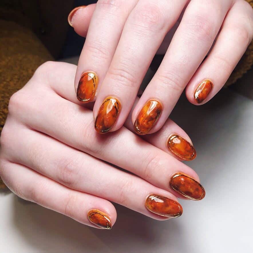 Discover the charm of amber nails with a variety of creative designs, from gel to acrylic styles. Find inspiration for your next manicure.