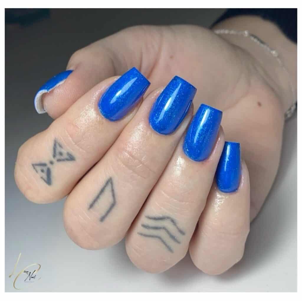 Varied blue nail designs showcasing light blue nails, royal blue acrylic nails, and blue French tips in different hand poses.