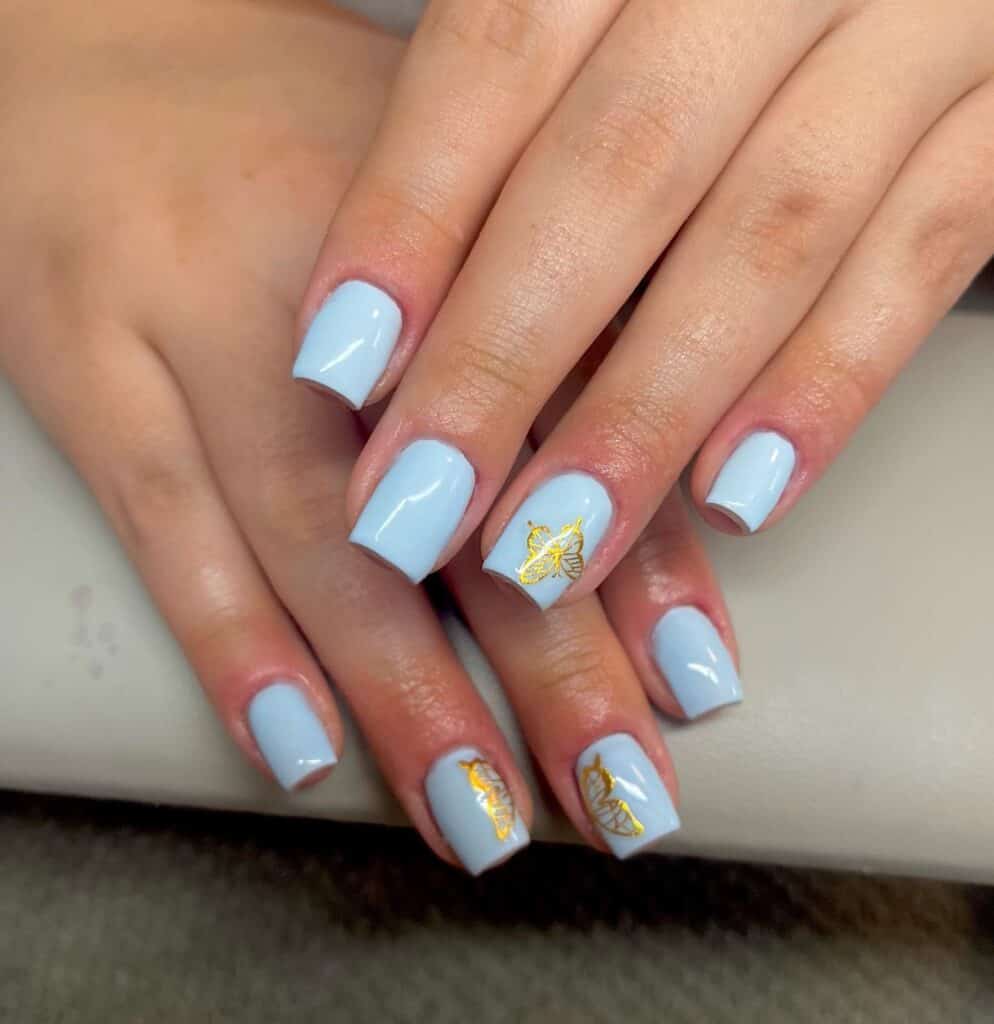 Varied blue nail designs showcasing light blue nails, royal blue acrylic nails, and blue French tips in different hand poses.