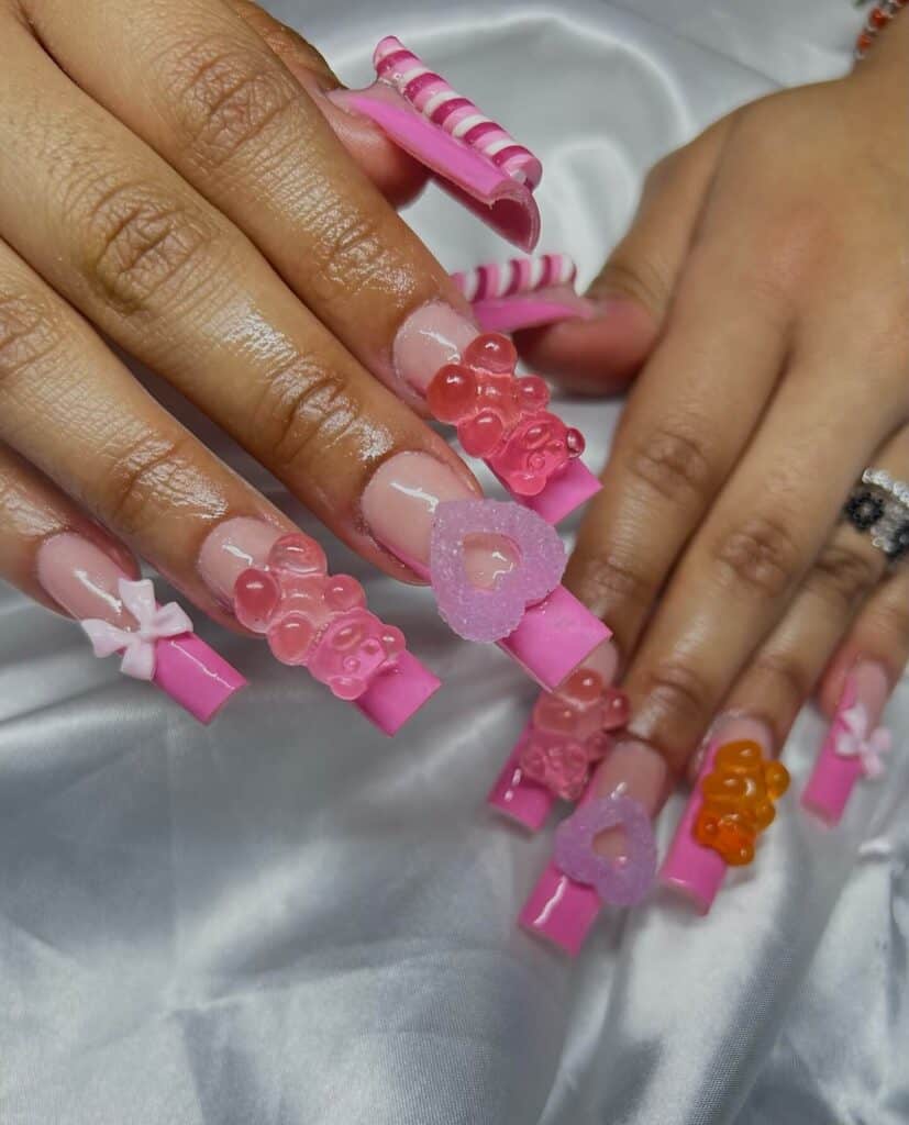 Detailed shot of festive nails showcasing candy cane stripes, lollipop swirls, and candy corn patterns in bright, vibrant hues.