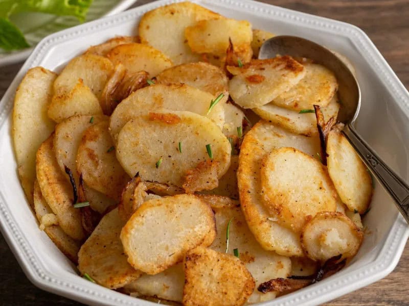 image 1231 - If anyone knows how to make potatoes somehow even more delicious, it would be the French! Potatoes Lyonnaise cooks the potatoes to golden brown crispiness in butter, so right from the get-go it's decadent and rich. Then the potatoes dance with butter-sautéed onions and refreshing rosemary, upping its savory flavor for even more appeal. It's simple, it's elegant, it's indulgent—it's potatoes like you've never had them before. Potatoes Lyonnaise makes mashed potatoes pale in comparison, and you get to eat the rewards!
