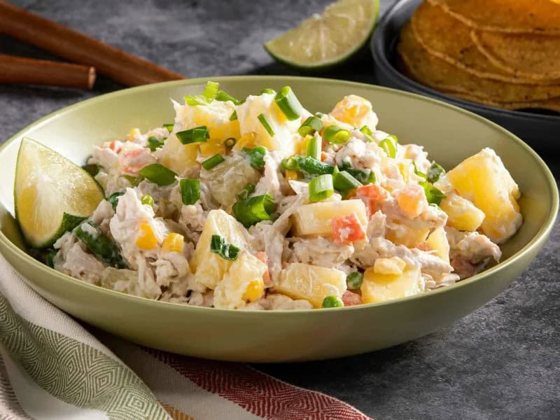 image 1253 - Ensalada de Pollo is a spicier, more flavorful, more daring version of the boring, bland chicken salad. Get ready to liven up your lunchtime! This amped-up dish still has the same creamy mayo base but with hints of sweet lime juice and spicy jalapeño brine to really make things interesting. To make sure your tummy isn't rumbling any time soon, it's loaded with tender shredded chicken, soft golden potatoes, and all the crispy veggies you can think of. Served on a tostada to really mix it up, with some salty tortilla chips, or nestled between two pieces of bread to make a sandwich, Ensalada de Pollo will make you even more excited for noon to roll around!