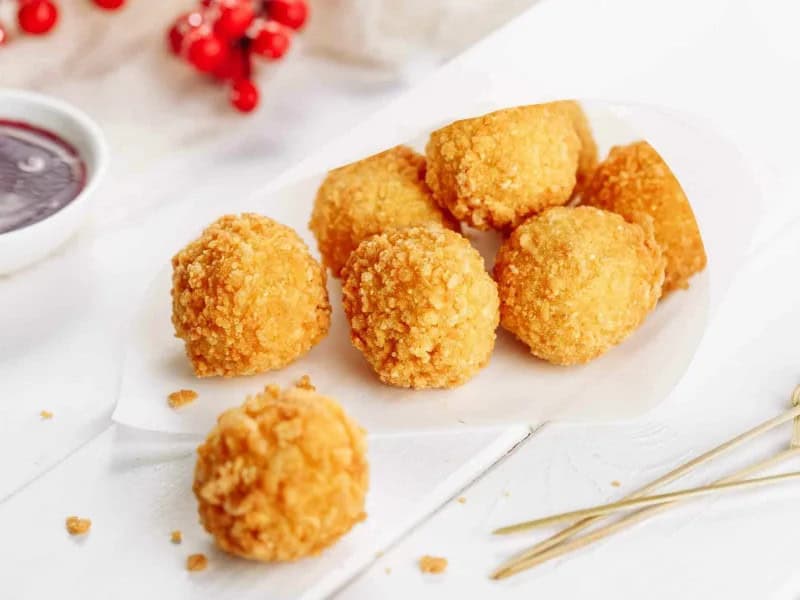 image 247 166 - If you make these Cheesy Chicken Balls, be warned: they’ll be gone in seconds! Creamy cheese, crunchy breadcrumbs, and tender chicken come together to create a tasty, bite-sized snack that everyone will enjoy. They are perfect for your next gathering or even a solo watch party for the next big game. Cheesy Chicken Balls will have you coming back for seconds and take only 30 minutes to make, so you can start enjoying them in a flash!