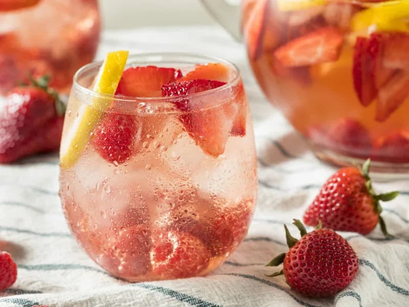 image 247 190 - Strawberry Champagne Punch is a party in a glass! It’s a simple, delicious punch to make for any holiday celebration, or on any regular old day when you want a fun drink. This yummy beverage uses just 3 ingredients and takes less than 5 minutes to make. The bubbly champagne pairs perfectly with the tart and sweet strawberries, and the ginger ale brings an added kick. Strawberry Champagne Punch is the essential drink to have in hand when you want to have a grand ol’ time!