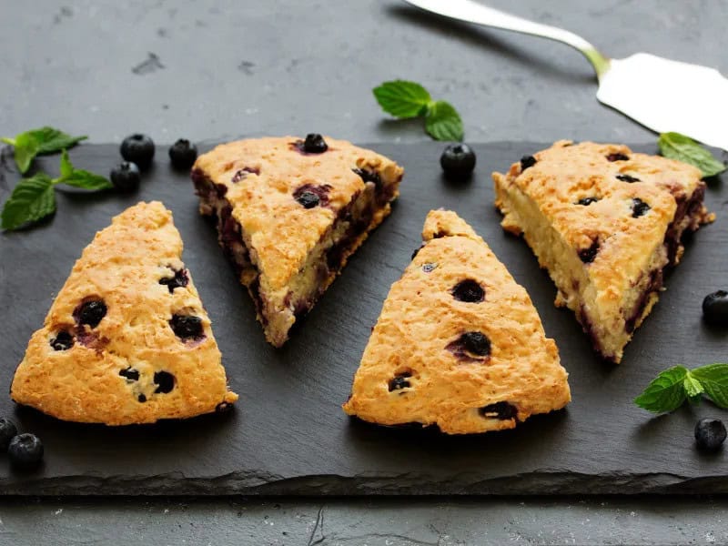 image 247 195 - Make your kitchen into a bakery with these Blueberry Scones! Each of these confections is moist on the inside with crispy edges, and packs all the delicious fruitiness of fresh blueberries. These scones can be served up for breakfast, brunch, or even high tea with a touch of clotted cream! Blueberry Scones are perfect for any occasion, and they’re easier to make than you think.