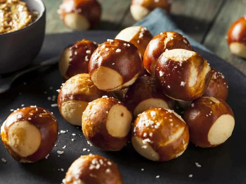 image 247 266 - This just in: one of the best bar snacks can now be enjoyed at home! These Brew Pub Pretzel Bites are delicious dipped in ground mustard or by themselves. Served alongside a rich homemade cheese sauce, they’re irresistible. These Brew Pub Pretzel Bites are savory, soft, and pillowy—eating them is a delightful experience. Turn on the game on the TV and get to munching on these yummy treats!