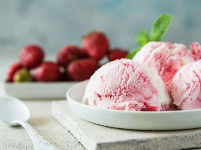 image 247 282 - Homemade Strawberry Ice Cream is fresher, creamier, and fruitier than anything you can find at the grocery store. It’s also amazingly easy to whip up, so in just a few hours you'll taste the most amazing ice cream of your life perfect for celebrating a hot summer day! Homemade Strawberry Ice Cream is infused with fresh strawberries with a citrus infusion to make it extra irresistible. Make sure you have your favorite ice cream toppings to serve alongside it!