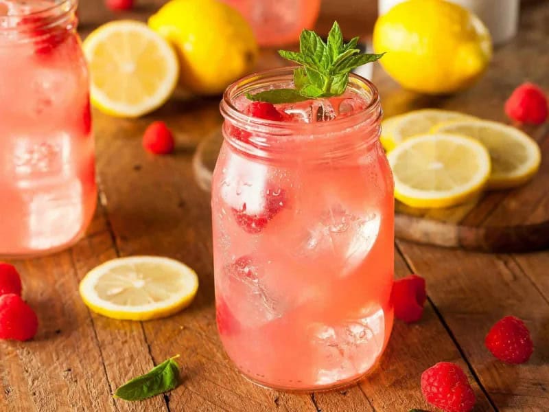 image 247 319 - Glenda's favorite way of staying cool in the summer is a tall glass of her homemade lemonade; once you try it, you'll pull up a chair so you can enjoy it in full, too! Glenda's Fresh Raspberry Lemonade infuses the sunny flavors of classic lemonade with the sweet, tart, and slightly floral flavor of raspberries. The result tastes like the best kind of peaceful, lazy afternoon, especially because it's easy and quick to whip up a whole bunch of glasses. Glenda's Fresh Raspberry Lemonade is a refreshing take on a great refreshment.