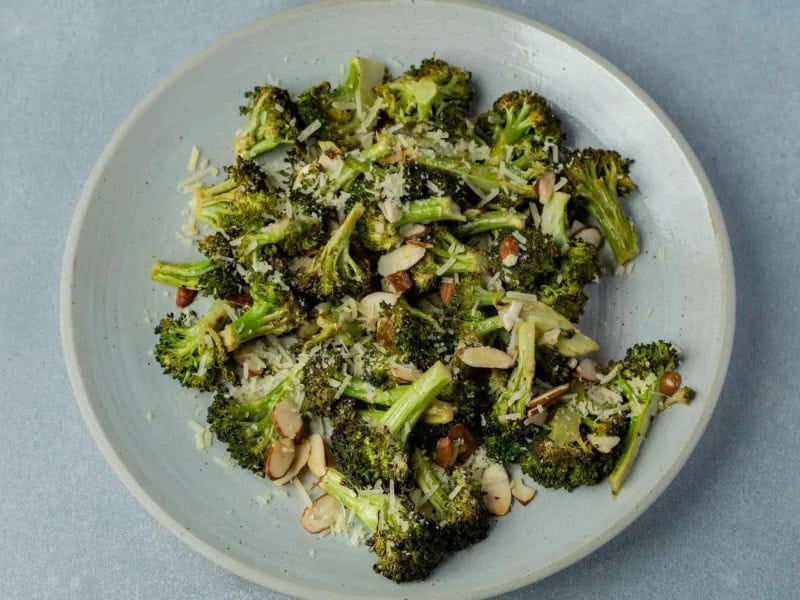 image 247 325 - Crack Broccoli is so appealing, so inherently delicious that even children would be excited to eat their vegetables if they were all like this. Crunchy, slightly sweet broccoli is roasted to a crisp golden brown and coated with tangy, fragrant spices and bright lemon flavors to maximize your tastebuds' joy! Crispy toasted almonds and sharp parmesan cheese just make comparing Crack Broccoli to other vegetable dishes simply unfair. This is a speedy side dish that will make you crack a smile!