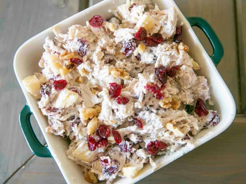 image 247 341 - Here comes the perfect picnic or road trip meal! Cranberry Walnut Chicken Salad is bursting with flavors of fresh herbs, dried berries, crisp lemon juice, and tender chicken. Serve it in a sandwich, over a bed of lettuce, or with some crackers; the sky truly is the limit! Cranberry Walnut Chicken Salad is a scrumptious spin on a classic, and it is sure to delight all.