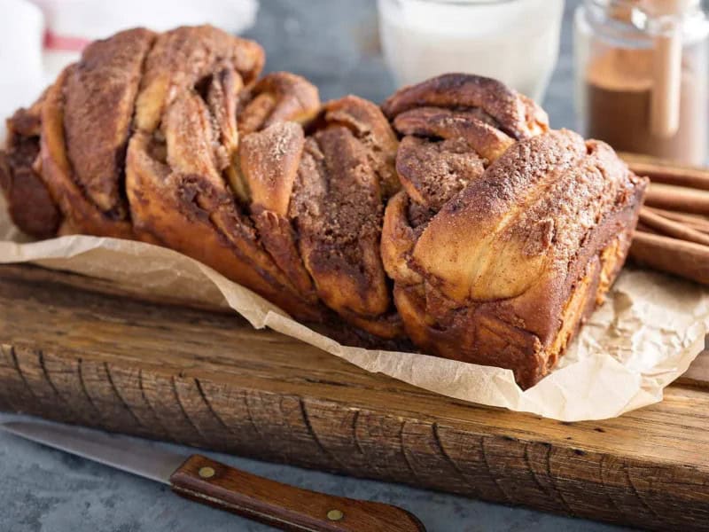 image 247 368 - Here's a loaf that will make you twist and shout! Twisted Cinnamon Bread is knotted with sweet cinnamon sugar, so every slice is aromatic, warm, and joyful! You can even think of Twisted Cinnamon Bread as a cinnamon roll in loaf form, perfect for serving with just a pat of butter or perhaps some homemade icing to make it feel extra special. This is a twist on a traditional breakfast that can turn the whole day around before it's even started!