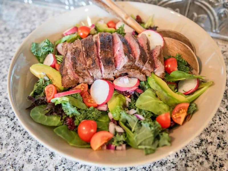 image 343 - Some steak salads can wow you simply by plating steak on top of a salad. Balsamic Steak Salad seeks to wow you by being the best steak and salad combination around for miles. The steak itself is grilled to a juicy, rosy medium-rare, elevated in its savory flavor with a tangy balsamic marinade... a marinade so good, in fact, that it's also used as the salad dressing. Meanwhile, the salad is fresh and bursting with bright tomato and cranberry flavors, a crunchy bed for the steak to rest its head on the journey to your tastebuds. Balsamic Steak Salad literally cannot disappoint!