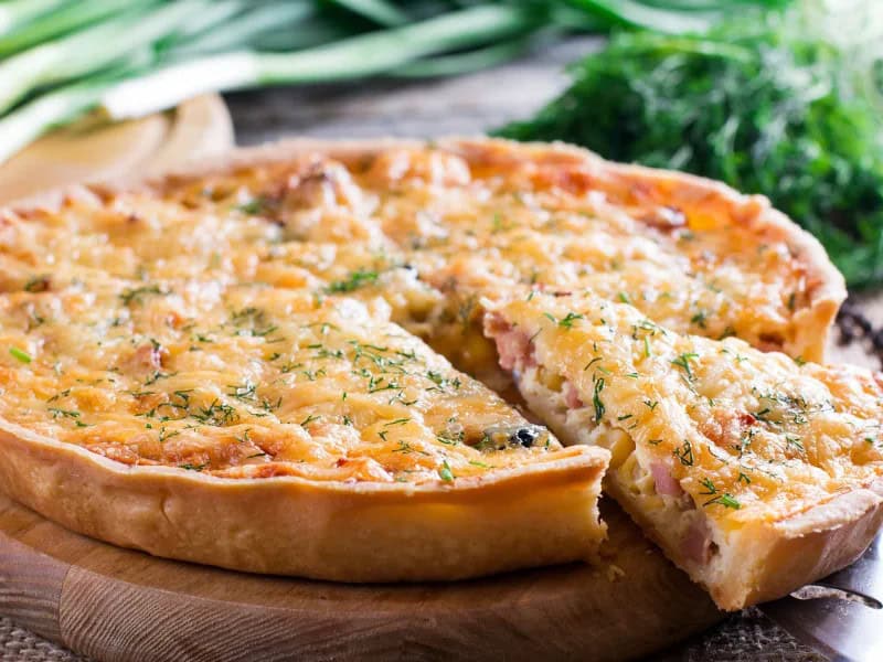image 489 - Easy Ham Quiche is quiche made simple! In less than an hour, you can enjoy a fresh and filling quiche for breakfast, brunch, or any meal of your choosing. Fluffy eggs are mixed with smoky ham, melted cheese, and fresh green onions, and enveloped by a crispy pie crust. Easy Ham Quiche is so delicious and low-effort, you’d think it took hours to make!