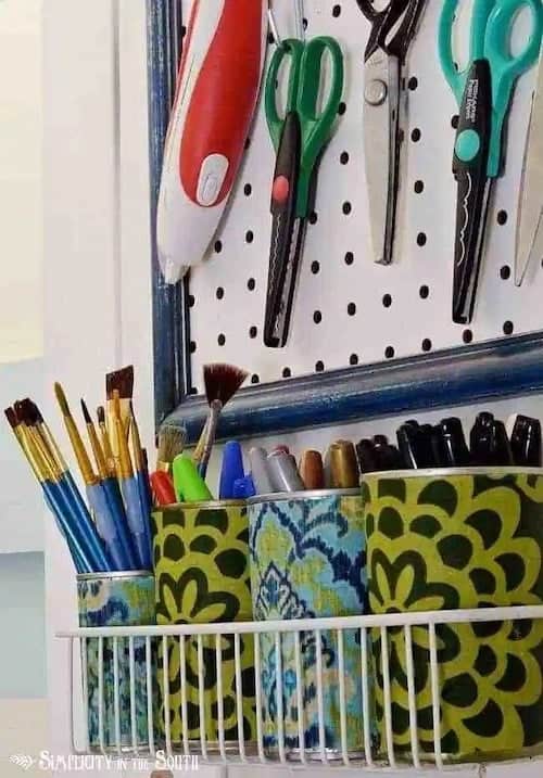 Fabric covered tin cans for storing craft supplies.jpg - Crafting is a joyful expression of creativity, but it comes with the challenge of organizing an ever-growing collection of supplies. For those who love to craft, keeping everything tidy and accessible is essential.