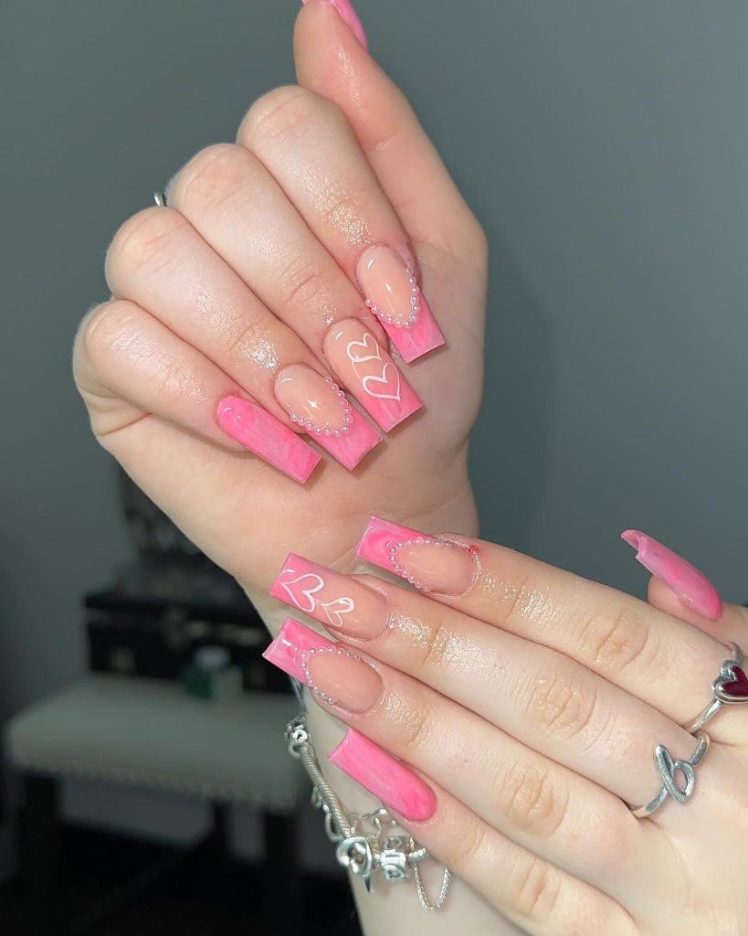 00009 Pink Nails With Gems - When it comes to pink nails with gems, nothing says elegance and glamour quite like a sparkling manicure. Whether you're dressing up for a special occasion or just want to add a little dazzle to your everyday look, pink nails with gems are the perfect choice. From soft pastel pinks with delicate rhinestones to bold hot pink nails dripping in crystals, this trend is all about making a statement.